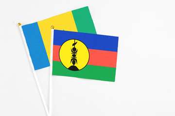 New Caledonia and Saint Vincent And The Grenadines stick flags on white background. High quality...