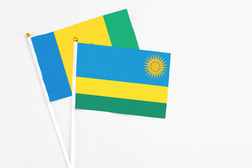 Rwanda and Saint Vincent And The Grenadines stick flags on white background. High quality fabric,...