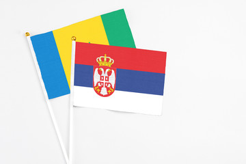 Serbia and Saint Vincent And The Grenadines stick flags on white background. High quality fabric,...