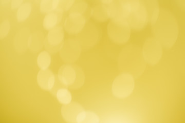 Yellow Gold Festive Christmas Beautiful abstract Background with bokeh lights. Holiday Texture with copy space. Can be used as Wallpaper, filling for a website, defocused