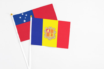 Andorra and Samoa stick flags on white background. High quality fabric, miniature national flag. Peaceful global concept.White floor for copy space.