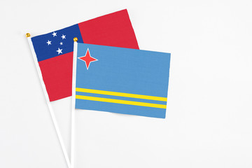 Aruba and Samoa stick flags on white background. High quality fabric, miniature national flag. Peaceful global concept.White floor for copy space.