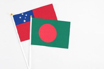 Bangladesh and Samoa stick flags on white background. High quality fabric, miniature national flag. Peaceful global concept.White floor for copy space.