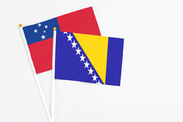 Bosnia Herzegovina and Samoa stick flags on white background. High quality fabric, miniature...