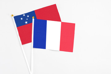 France and Samoa stick flags on white background. High quality fabric, miniature national flag. Peaceful global concept.White floor for copy space.