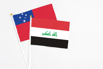 Iraq and Samoa stick flags on white background. High quality fabric, miniature national flag. Peaceful global concept.White floor for copy space.