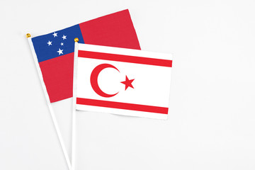 Northern Cyprus and Samoa stick flags on white background. High quality fabric, miniature national flag. Peaceful global concept.White floor for copy space.