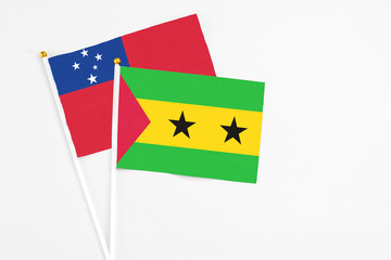 Sao Tome And Principe and Samoa stick flags on white background. High quality fabric, miniature national flag. Peaceful global concept.White floor for copy space.