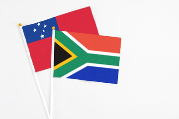South Africa and Samoa stick flags on white background. High quality fabric, miniature national flag. Peaceful global concept.White floor for copy space.