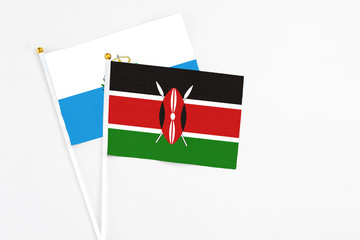 Kenya and San Marino stick flags on white background. High quality fabric, miniature national flag. Peaceful global concept.White floor for copy space.