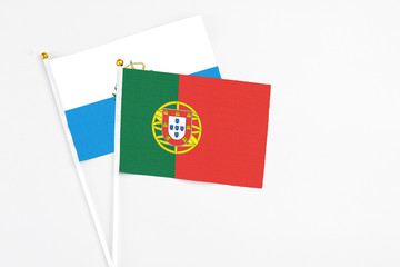 Portugal and San Marino stick flags on white background. High quality fabric, miniature national flag. Peaceful global concept.White floor for copy space.