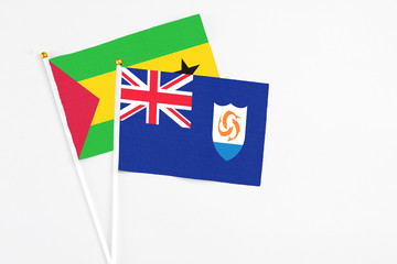 Anguilla and Sao Tome And Principe stick flags on white background. High quality fabric, miniature national flag. Peaceful global concept.White floor for copy space.