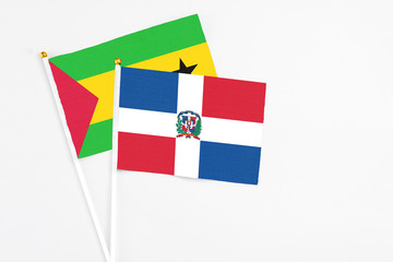 Dominican Republic and Sao Tome And Principe stick flags on white background. High quality fabric, miniature national flag. Peaceful global concept.White floor for copy space.