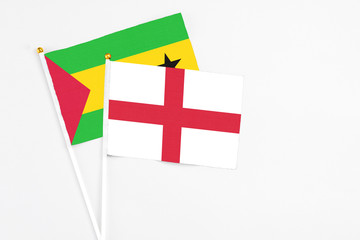 England and Sao Tome And Principe stick flags on white background. High quality fabric, miniature national flag. Peaceful global concept.White floor for copy space.