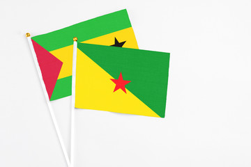French Guiana and Sao Tome And Principe stick flags on white background. High quality fabric,...