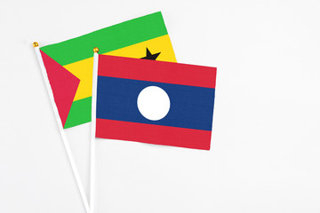 Laos and Sao Tome And Principe stick flags on white background. High quality fabric, miniature national flag. Peaceful global concept.White floor for copy space.