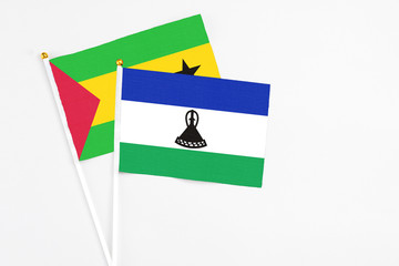 Lesotho and Sao Tome And Principe stick flags on white background. High quality fabric, miniature national flag. Peaceful global concept.White floor for copy space.