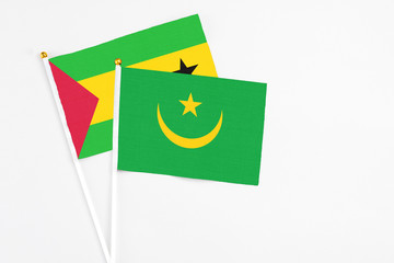Mauritania and Sao Tome And Principe stick flags on white background. High quality fabric, miniature national flag. Peaceful global concept.White floor for copy space.