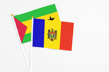 Moldova and Sao Tome And Principe stick flags on white background. High quality fabric, miniature national flag. Peaceful global concept.White floor for copy space.