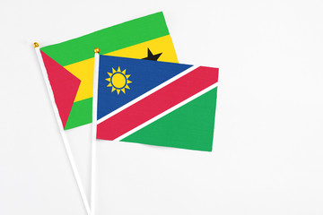 Namibia and Sao Tome And Principe stick flags on white background. High quality fabric, miniature national flag. Peaceful global concept.White floor for copy space.