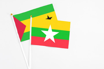 Myanmar and Sao Tome And Principe stick flags on white background. High quality fabric, miniature national flag. Peaceful global concept.White floor for copy space.