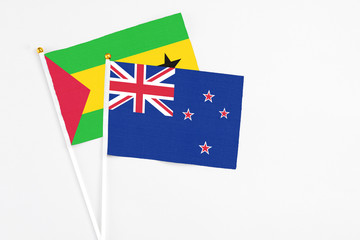 New Zealand and Sao Tome And Principe stick flags on white background. High quality fabric,...