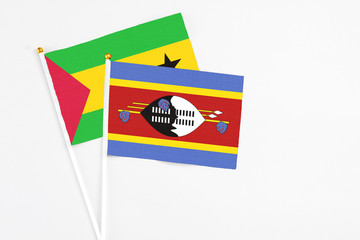 Swaziland and Sao Tome And Principe stick flags on white background. High quality fabric, miniature national flag. Peaceful global concept.White floor for copy space.