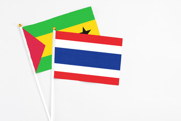 Thailand and Sao Tome And Principe stick flags on white background. High quality fabric, miniature national flag. Peaceful global concept.White floor for copy space.