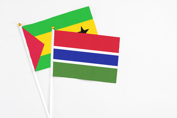 Gambia and Saudi Arabia stick flags on white background. High quality fabric, miniature national flag. Peaceful global concept.White floor for copy space.