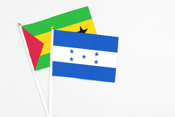 Honduras and Saudi Arabia stick flags on white background. High quality fabric, miniature national flag. Peaceful global concept.White floor for copy space.