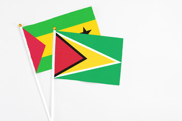 Guyana and Saudi Arabia stick flags on white background. High quality fabric, miniature national flag. Peaceful global concept.White floor for copy space.