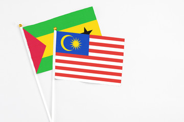 Malaysia and Saudi Arabia stick flags on white background. High quality fabric, miniature national flag. Peaceful global concept.White floor for copy space.