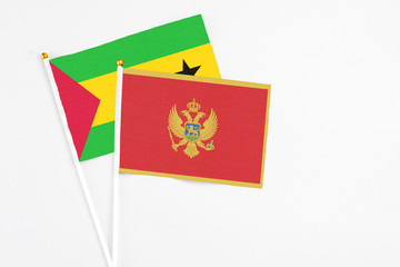Montenegro and Saudi Arabia stick flags on white background. High quality fabric, miniature national flag. Peaceful global concept.White floor for copy space.