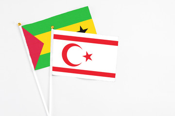 Northern Cyprus and Saudi Arabia stick flags on white background. High quality fabric, miniature national flag. Peaceful global concept.White floor for copy space.