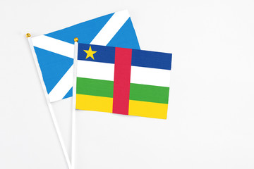 Central African Republic and Scotland stick flags on white background. High quality fabric, miniature national flag. Peaceful global concept.White floor for copy space.
