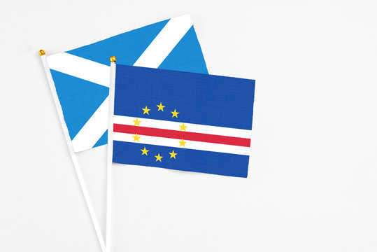 Cape Verde and Scotland stick flags on white background. High quality fabric, miniature national flag. Peaceful global concept.White floor for copy space.