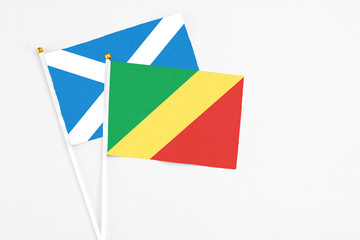Republic Of The Congo and Scotland stick flags on white background. High quality fabric, miniature national flag. Peaceful global concept.White floor for copy space.