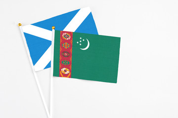 Turkmenistan and Scotland stick flags on white background. High quality fabric, miniature national...