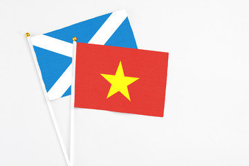 Vietnam and Scotland stick flags on white background. High quality fabric, miniature national flag. Peaceful global concept.White floor for copy space.