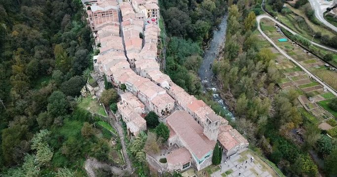 Aerial view of Castellfollit de la Roca, medieval Catalan hamlet on cliff on autumn day