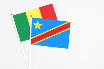 Congo and Senegal stick flags on white background. High quality fabric, miniature national flag. Peaceful global concept.White floor for copy space.