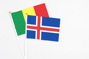 Iceland and Senegal stick flags on white background. High quality fabric, miniature national flag. Peaceful global concept.White floor for copy space.