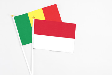 Indonesia and Senegal stick flags on white background. High quality fabric, miniature national flag. Peaceful global concept.White floor for copy space.