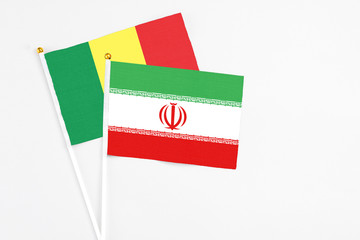 Iran and Senegal stick flags on white background. High quality fabric, miniature national flag. Peaceful global concept.White floor for copy space.