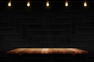 Empty brown plank wood shelf at black modern tile wall background with light bulbs string,Mockup...