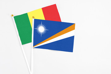 Marshall Islands and Senegal stick flags on white background. High quality fabric, miniature national flag. Peaceful global concept.White floor for copy space.