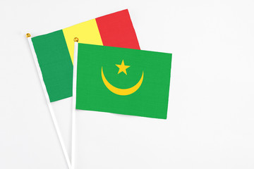 Mauritania and Senegal stick flags on white background. High quality fabric, miniature national flag. Peaceful global concept.White floor for copy space.