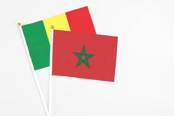 Morocco and Senegal stick flags on white background. High quality fabric, miniature national flag. Peaceful global concept.White floor for copy space.