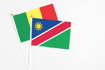 Namibia and Senegal stick flags on white background. High quality fabric, miniature national flag. Peaceful global concept.White floor for copy space.