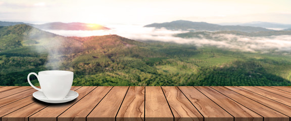 long wooden table and morning coffee with morning landscape blur background